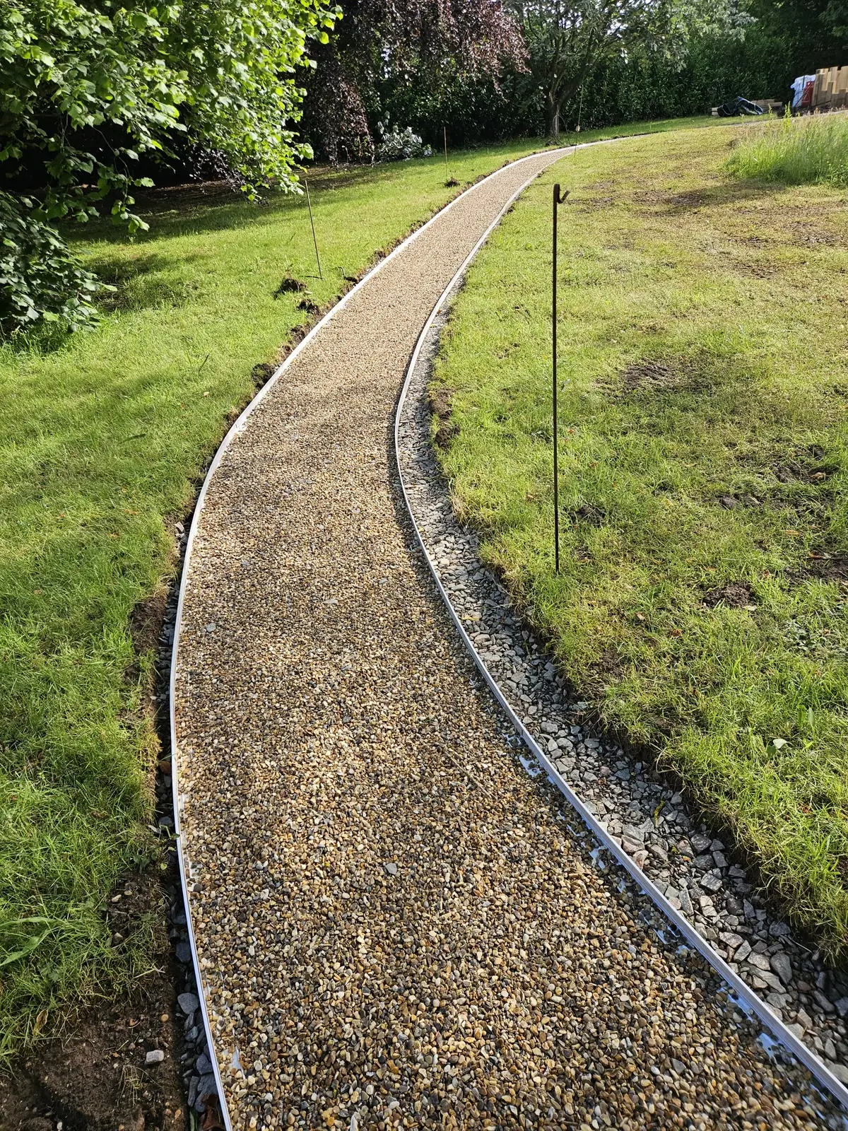 Aurora resin bound path held between edge restraints with a permeable drainage edge