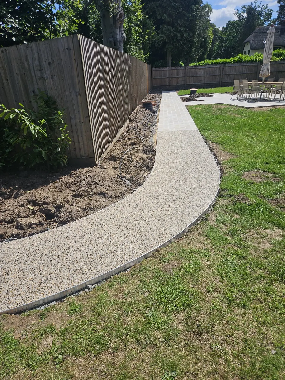 Aurora resin bound surface in a landscaped back garden, permeable and trip-free, Aspley Guise