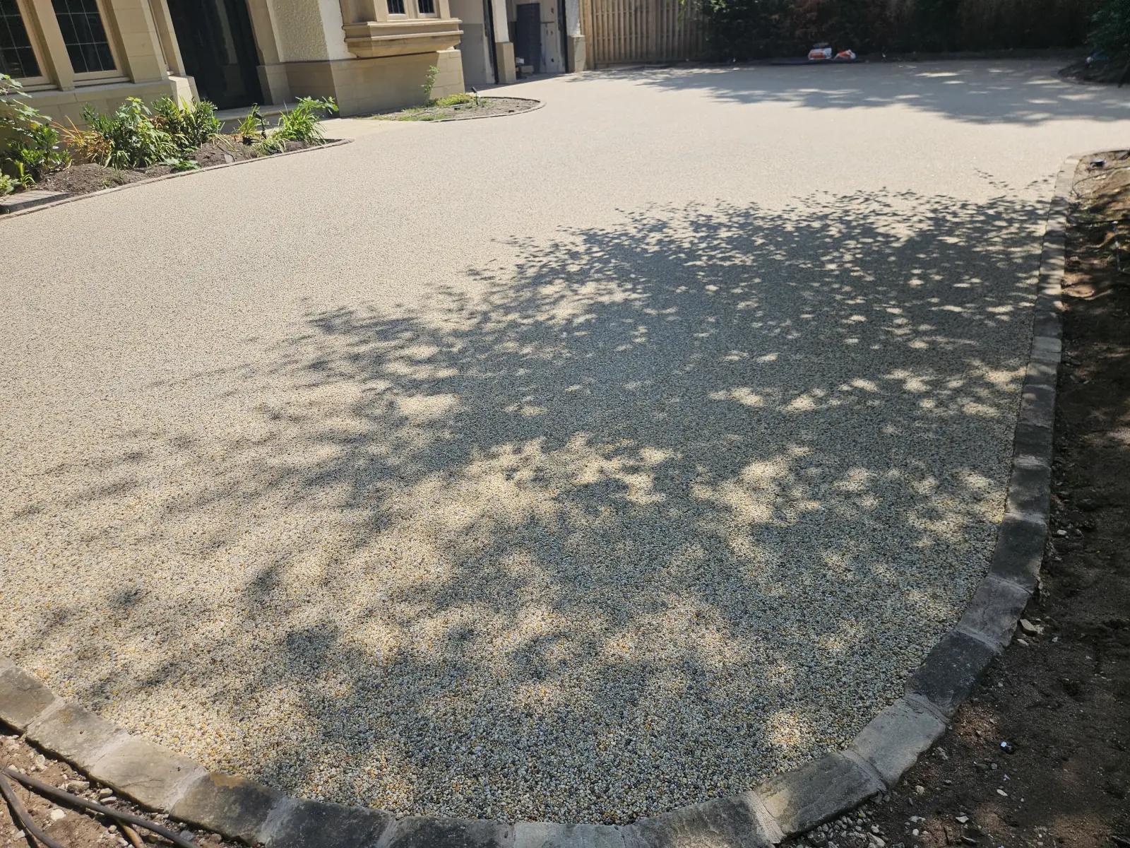 Aurora resin bound driveway sweeping across the frontage at a home in Hale Barns